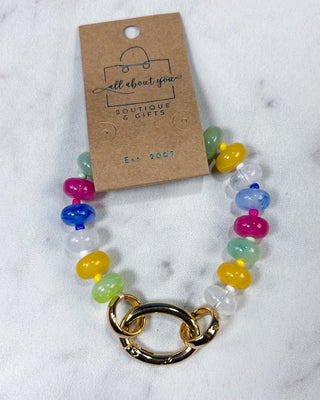 A multicolor beaded bracelet with a gold-toned interlocking chain clasp, d