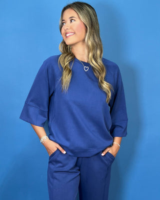 a matching royal blue lounge set consisting of a short-sleeve top with wide three-quarter sleeves and matching pants