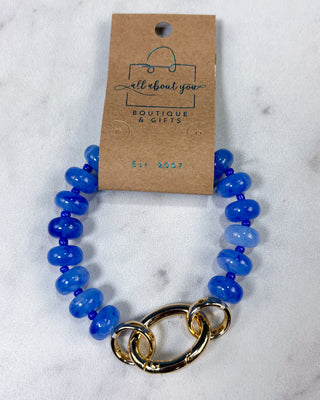 A blue beaded bracelet with a chunky gold link clasp, 