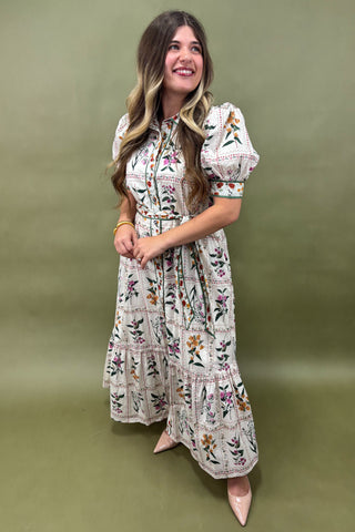 Woman wearing a floral dress against an olive green background