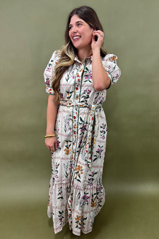 Woman wearing a floral dress against a green background