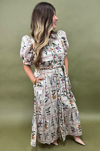 Woman wearing a floral dress against a green background