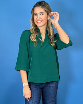 Emerald green textured blouse featuring a split V-neckline with a pleated stand collar, three-quarter sleeves, and an easy relaxed fit.