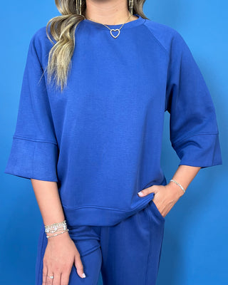 a matching royal blue lounge set consisting of a short-sleeve top with wide three-quarter sleeves and matching pants