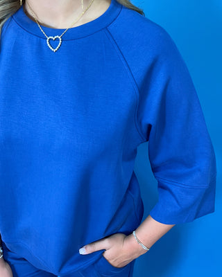 a matching royal blue lounge set consisting of a short-sleeve top with wide three-quarter sleeves and matching pants