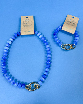 A beaded necklace and matching bracelet set in shades of blue