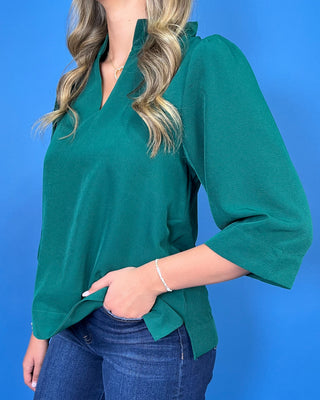 Emerald green textured blouse featuring a split V-neckline with a pleated stand collar, three-quarter sleeves, and an easy relaxed fit.