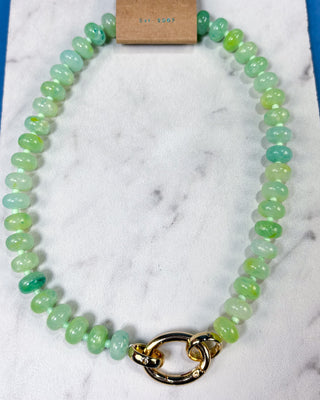 A beaded necklace made of polished light green and mint green oval beads