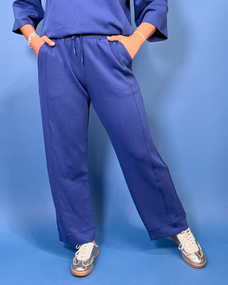 wide-leg blue sweatpants with a drawstring waist, paired with a matching blue top