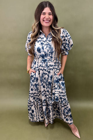 Woman wearing a floral dress against a green background
