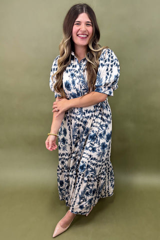 Woman wearing a floral dress against a green background
