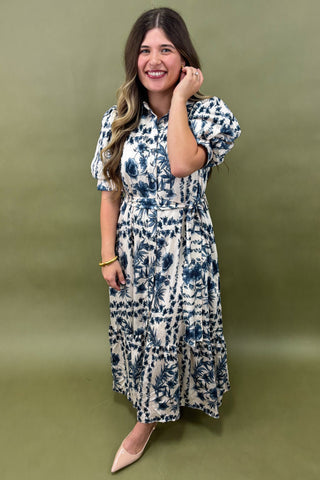 Woman wearing a floral dress against a green background