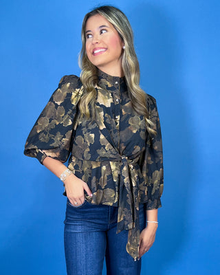 Black floral blouse featuring a high neckline, button-front detail, three-quarter puff sleeves, and a coordinating waist tie for a flattering finish.