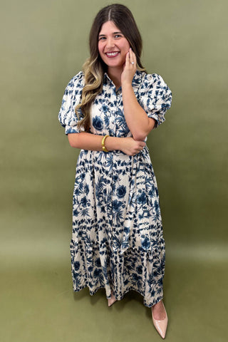 Woman wearing a floral dress against a green background