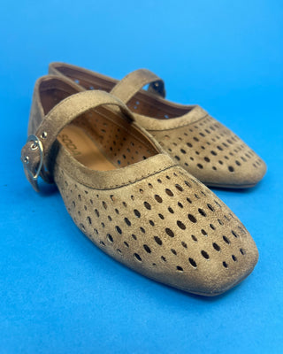 Brown Faux Suede Mary Jeane One Strap Mule held up against a solid blue background. 