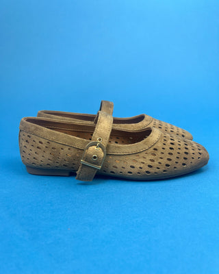 Brown Faux Suede Mary Jeane One Strap Mule held up against a solid blue background. 