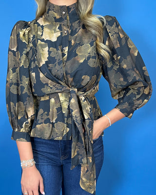 Black floral blouse featuring a high neckline, button-front detail, three-quarter puff sleeves, and a coordinating waist tie for a flattering finish.