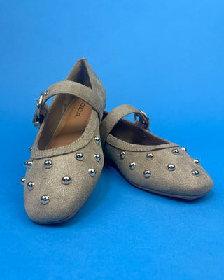 Gold Studded Brown One Strap Mary Jane Flats against a solid blue background. 