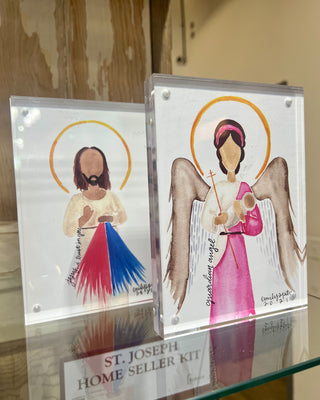 Two religious-themed cards featuring illustrations of a child and an angel on a glass surface.
