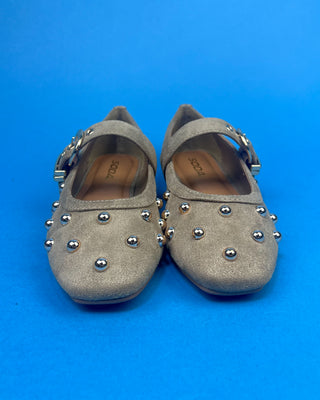 Gold Studded Brown One Strap Mary Jane Flats against a solid blue background. 