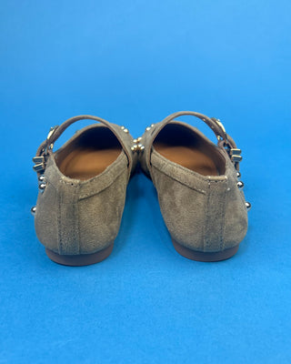 Gold Studded Brown One Strap Mary Jane Flats against a solid blue background. 