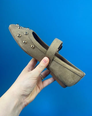 Gold Studded Brown One Strap Mary Jane Flats against a solid blue background. 