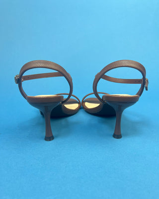 Brown Single Strap 3in Heel Open Toe Heel against a solid blue background. 