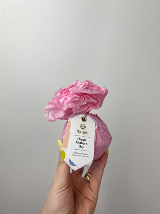 Pink flower-shaped product with 'Happy Mother's Day' tag held by a hand against a plain background
