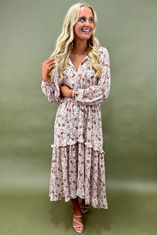 Woman wearing a floral dress against a green background