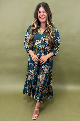 Woman wearing a floral dress against a green background