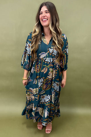 Woman wearing a floral dress against an olive green background