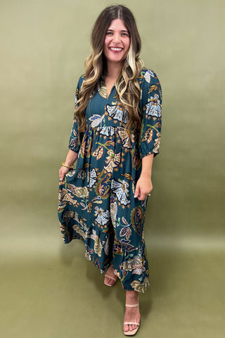 Woman wearing a floral dress against a green background