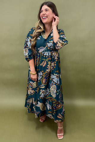 Woman wearing a floral dress against an olive green background