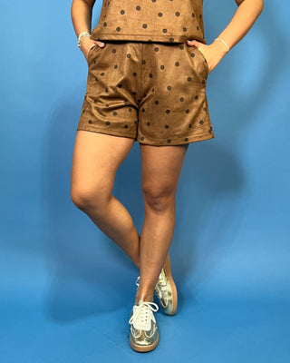 brown shorts with a black polka dot pattern, paired with a matching top