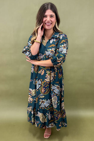 Woman wearing a floral dress against a green background