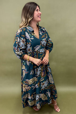 Woman wearing a floral dress against a green background
