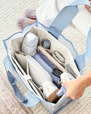 Case Mate Tote Bag Organizer Inserts in Colors Mulberry, Ballet Pink, & French Vanilla displayed against a slid blue background. 