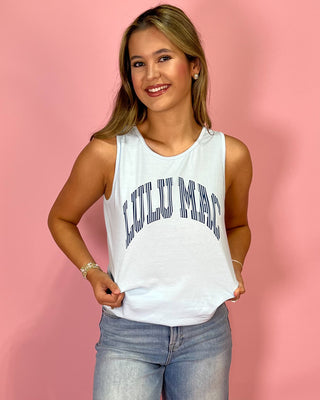 Woman wearing a white tank top with 'Lulu Lac' text against a pink background
