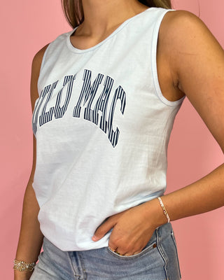 Person wearing a white sleeveless top with text on a pink background