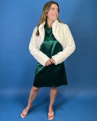 Ivory faux fur cropped jacket featuring a plush texture, open-front design, structured collar, and long sleeves.