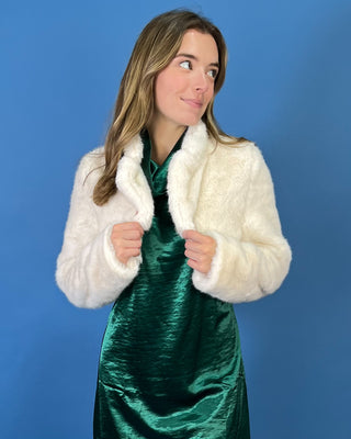 Ivory faux fur cropped jacket featuring a plush texture, open-front design, structured collar, and long sleeves.