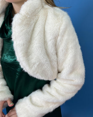 Ivory faux fur cropped jacket featuring a plush texture, open-front design, structured collar, and long sleeves.