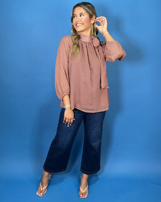 Mocha and blush dot print blouse with a high tie neckline, long sleeves, and a relaxed flowy fit.