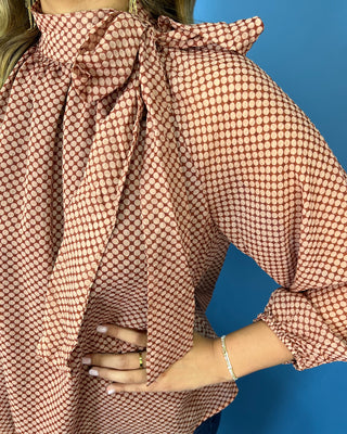 Mocha and blush dot print blouse with a high tie neckline, long sleeves, and a relaxed flowy fit.