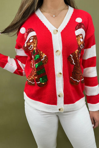 Red cardigan with gingerbread design on a plain background