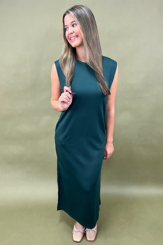 Woman wearing a green dress against a plain background