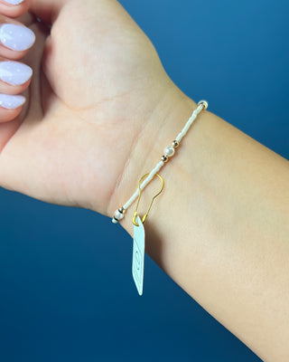 Enewton Hope Purpose Pearl Milkshake Bracelet against a solid blue background. 