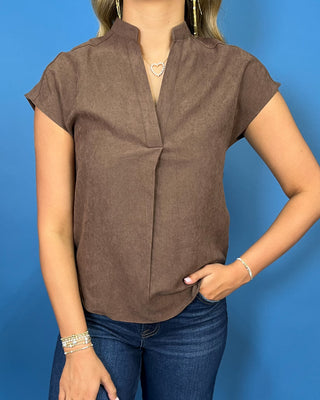 Mocha brown cap sleeve blouse with a split V-neckline, subtle textured finish, and relaxed fit.