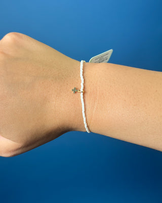Hope Classic Signature Cross Milkshake Bracelet displayed against a solid blue background. 