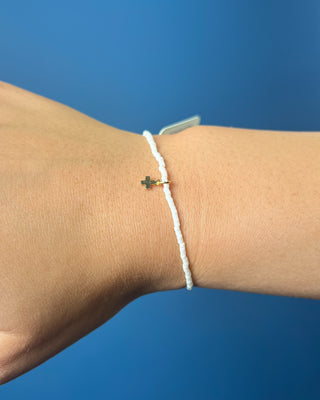 Hope Classic Signature Cross Milkshake Bracelet displayed against a solid blue background. 